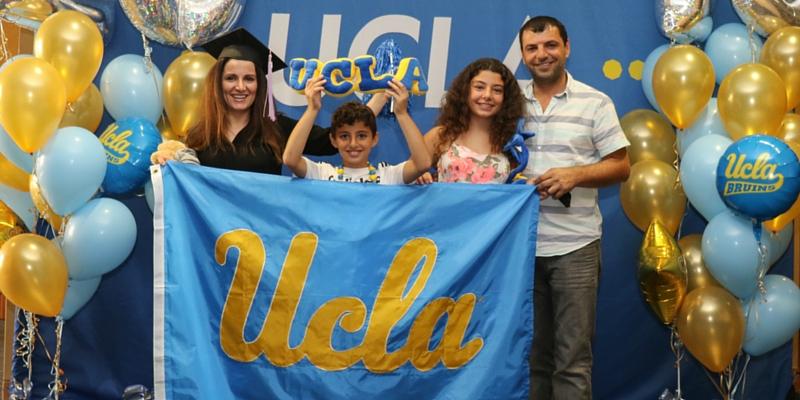 two adults and two kids at a UCLA graduation event